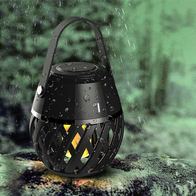 Waterproof portable Bluetooth speaker with a flame effect, designed for outdoor and indoor use.