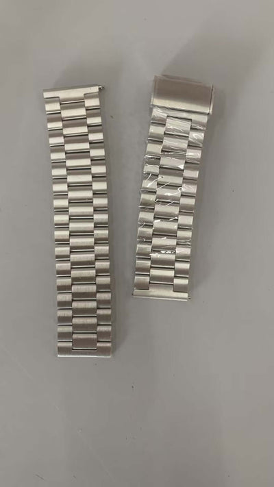 Two metal watch bands laid side by side, showcasing a sleek and modern design, ideal for smart watches.