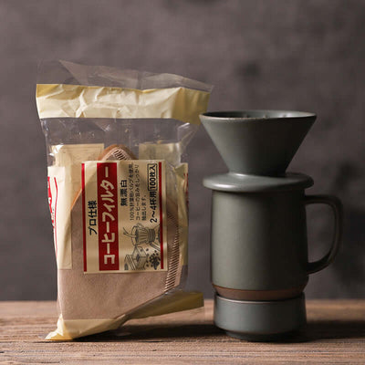 ElectroncHub ceramic drip coffee filter cup with coffee filters, ideal for hand-brewed coffee preparation.